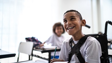 Child in a wheelchair smiling